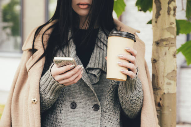 istock woman with smartphone and coffee 904113062