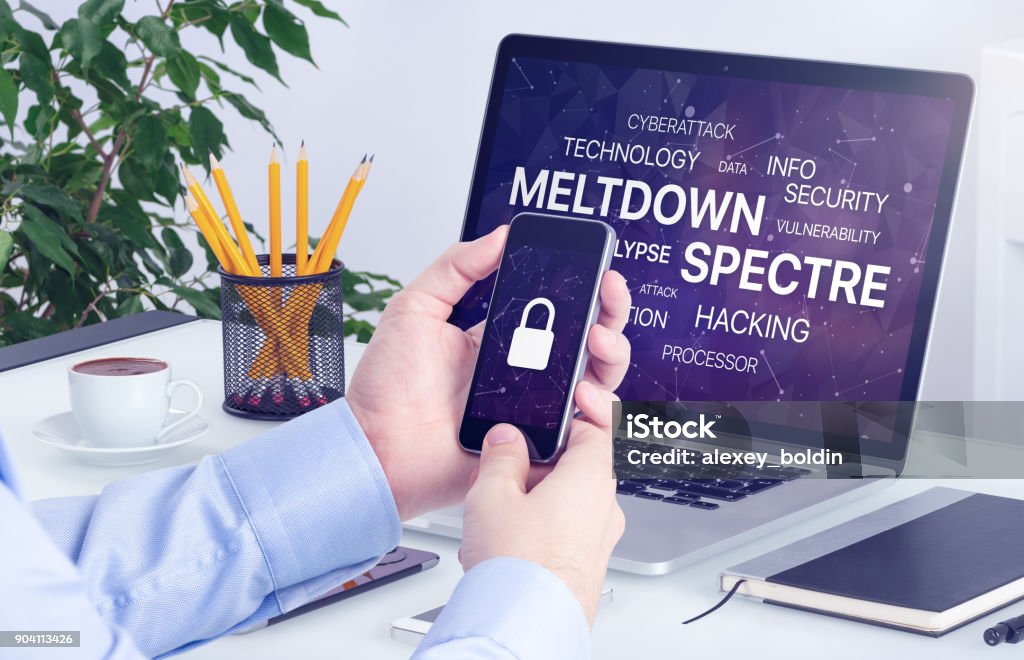 Meltdown and spectre threat concept on laptop and smartphone screen Meltdown and spectre vulnerability concept. Chipocalypse meltdown and spectre threat on laptop and smartphone screen. Adult Stock Photo