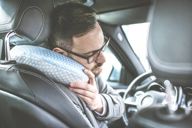Tired young man in car.
