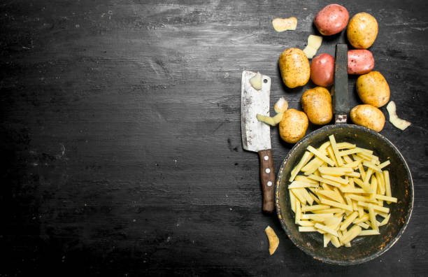 istock Sliced potatoes in an old frying pan. 904114888