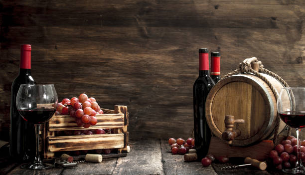 istock Wine background. A barrel with red wine and freshly grapes. 904115248