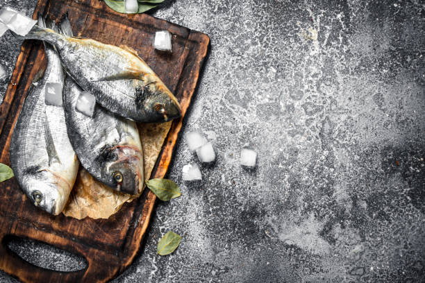 istock Fresh unprepared dorado fish on a cutting board. 904118316