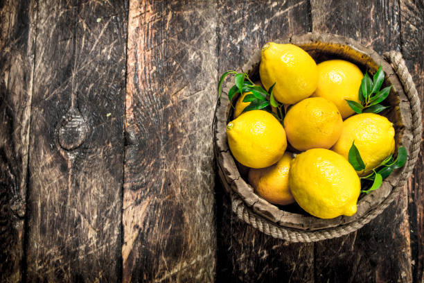 istock Fresh lemons in a wooden bucket. 904118986