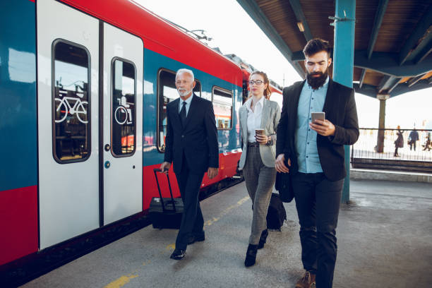 istock Businessman using mobile phone at train station 904127238