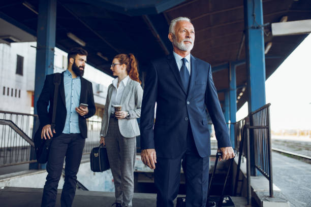 istock Business people with luggage at train station. 904127448