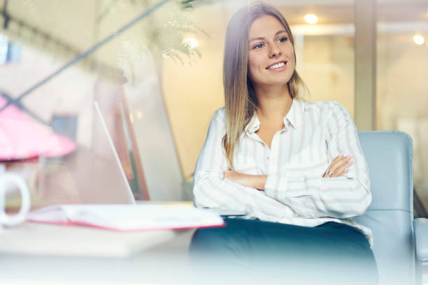istock Positive young woman looking in side enjoying free time during working process.Beautiful creative designer thinking about new ideas sitting at laptop computer device in coworking office 904127574