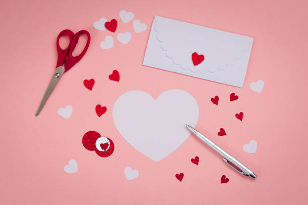 istock Signing Handmade Valentine cards. Felt, silver pen. white envelope, scissors. 904131792