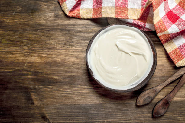 istock Natural yogurt in a bowl with a spoon. 904136432