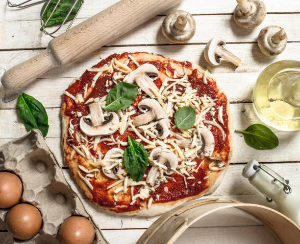 istock Preparation of pizza with various ingredients. 904136852