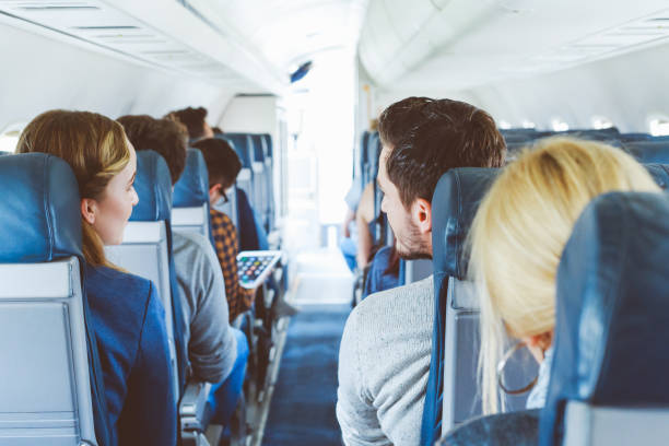 istock Commercial airliner cabin with people travelling 904137192