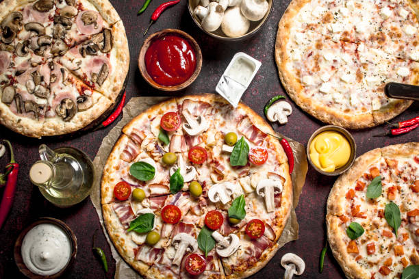 istock variety of pizzas with sauces. 904138928