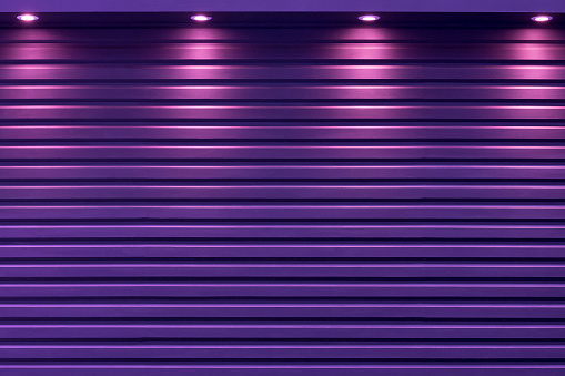 The purple shutter door with the light from spotlight background.