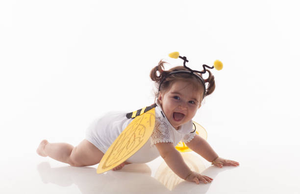 Little baby girls sitting over white background