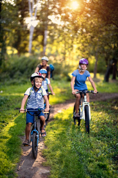 istock Happy family enjoying bicycle ride in park 904149532