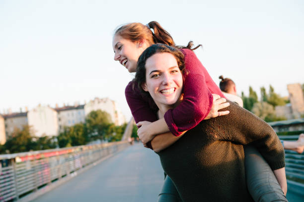 istock Friendship: young adults have fun with piggyback, summer in Berlin 904150250