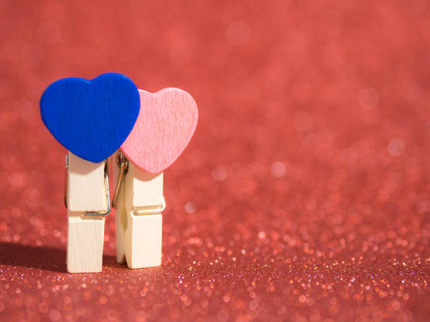 istock couple clothes pin whit hart on red abstract glitter background with bokeh. lights blurry soft red for the romance background. Copy space for text, Valentines day, love concept and couple concept 904150678