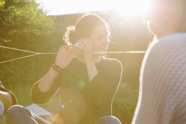 istock cans communication: young adults talking with tin can phones 904150904