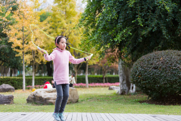 istock Girl jumping rope in garden. 904153690