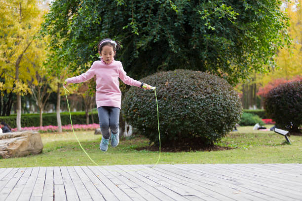istock Girl jumping rope in garden. 904153936