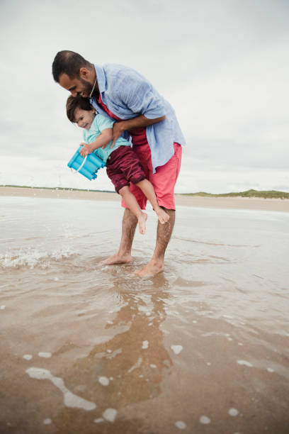 istock Father And Son Playing On The Beach 904154462