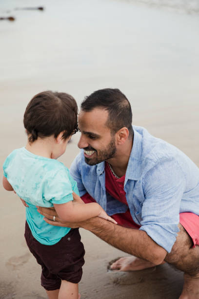 istock Father And Son Playing On The Beach 904157368