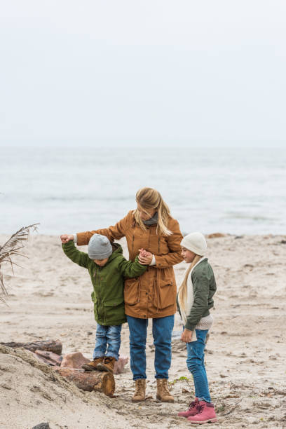 istock mother and kids on seashore 904161304