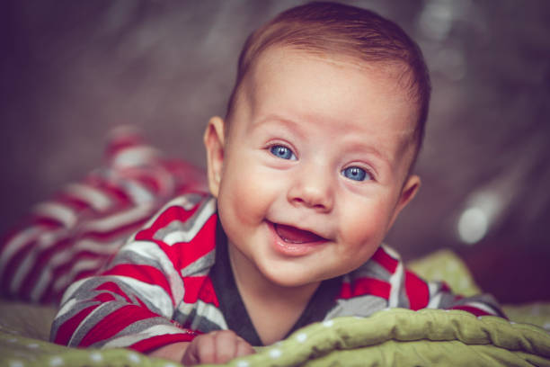 Happy 4 months baby boy indoors