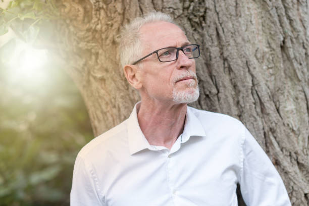 istock Portrait of thoughtful mature man, light effect 904169836