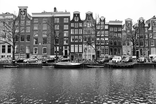 Amsterdam, NETHERLANDS - Dec 13, 2017: View on the beautiful old buildings and water channel in Amsterdam city