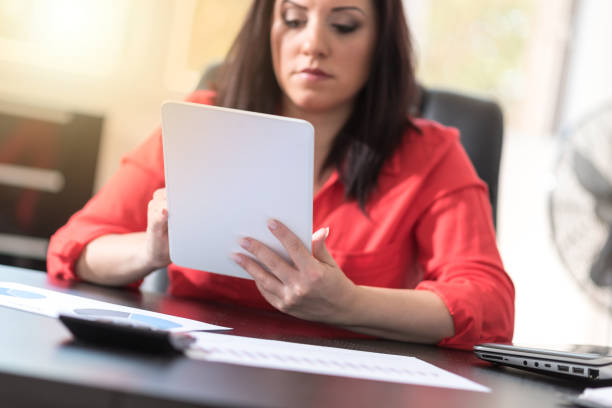 istock Young attractive businesswoman using a tablet, light effect 904170618