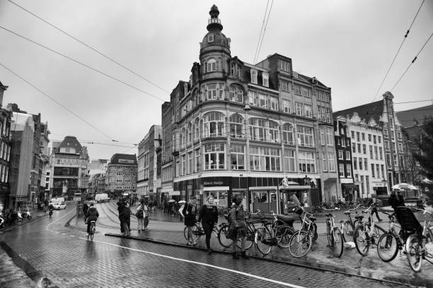 Amsterdam, Netherlands - Dec 13, 2017:Rainy day in the centre of Amsterdam. Famous Dutch architecture in the centre of composition. You can find modern architectonic creations next to historical buildings in the city.