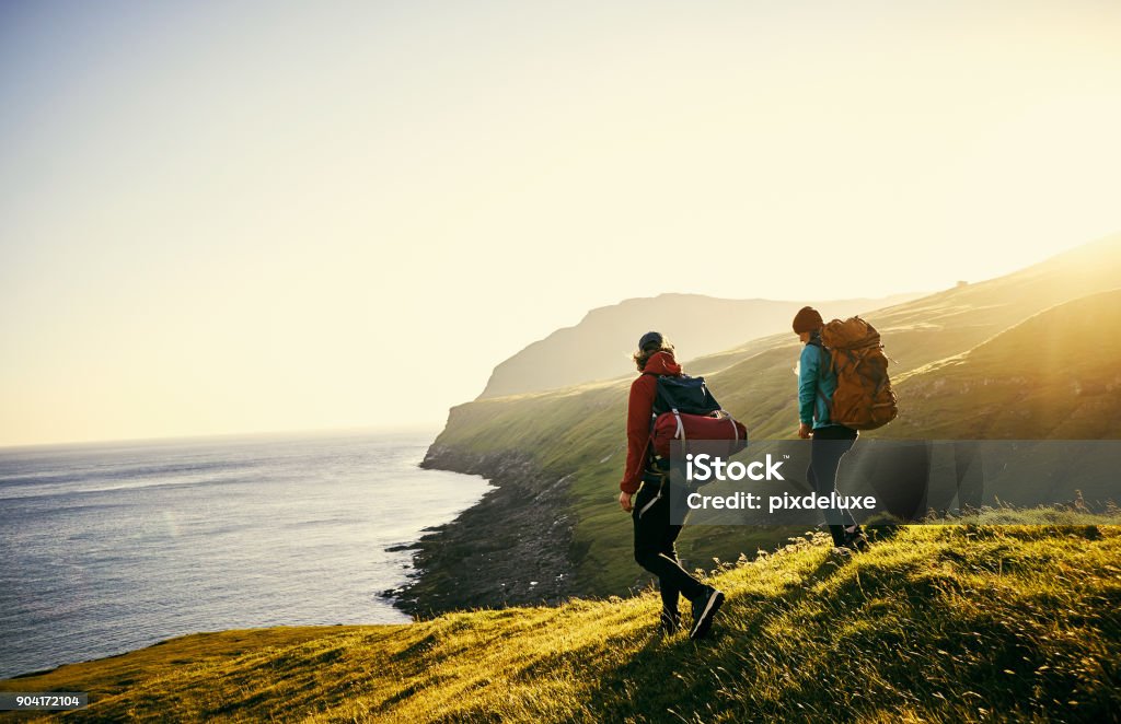 We've made it all this way, I am proud Shot of a young couple hiking through the mountains Hiking Stock Photo