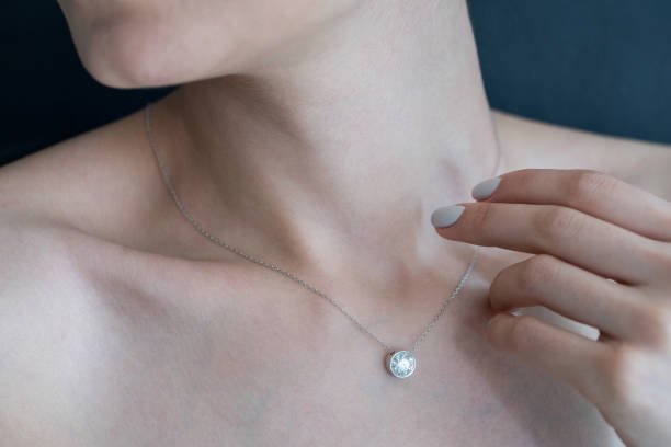 istock Woman wearing shiny diamond pendant 904172578
