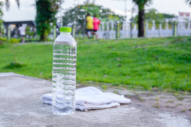 istock Plastic water bottle and white cloth on desk with running exercise people 904172758