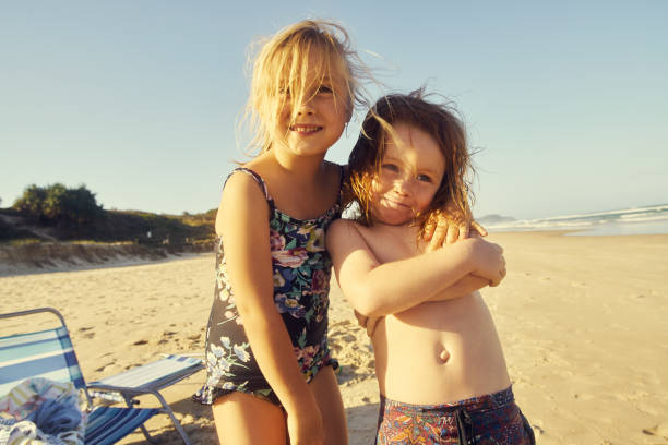 Shot of a happy brother and sister enjoying a day at the beach
