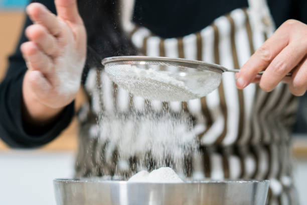 istock Sifting flour powder to make bread 904177436