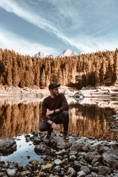 istock man alone at carezza lake in italy 904186054