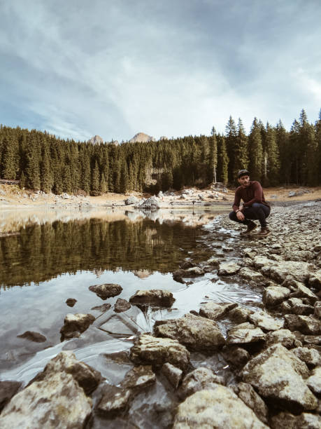 istock man alone at carezza lake in italy 904186148