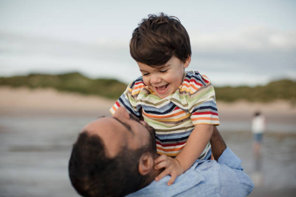 istock Father And Son Playing On The Beach 904191852