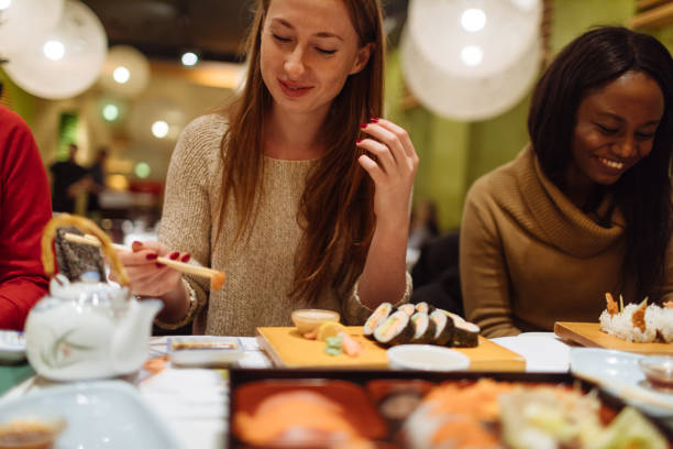 Multi-ethnic group of female friends who enjoy together in each other's company, during dinner in a Chinese restaurant