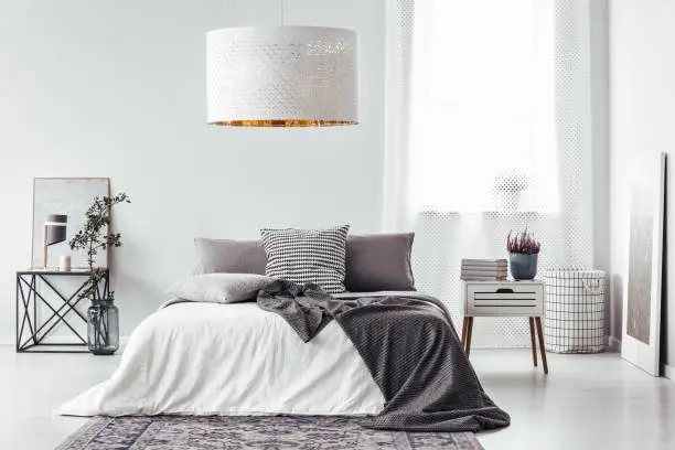 Photo of White lamp above bed
