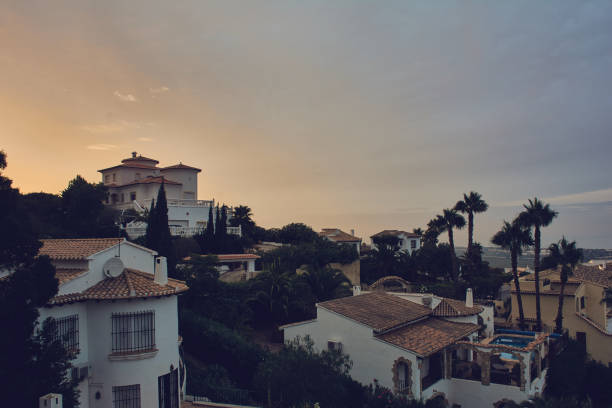 istock Houses In Town Against Sky At Sunset 904200972