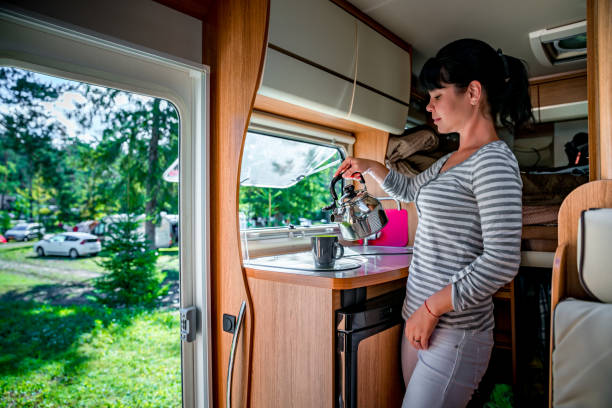 istock Woman cooking in camper, motorhome interior RV 904207886