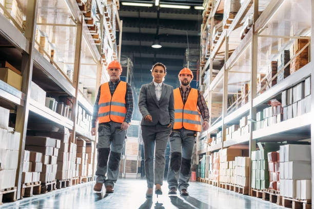 istock workers and inspector going along the corridor in shipping stock 904208248