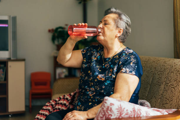 istock Senior woman drinking from a water bottle 904214952