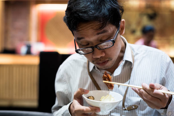 istock portrait man eating grilled. 904215496