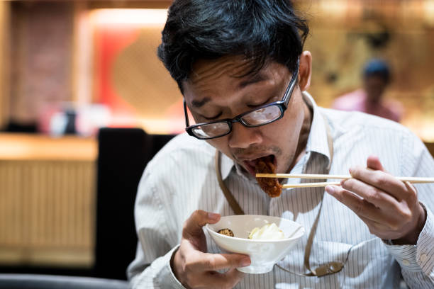 istock portrait man eating grilled. 904216090