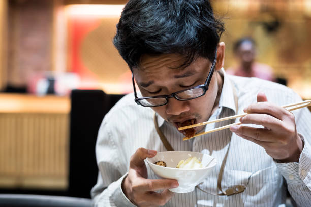 istock portrait man eating grilled. 904217204