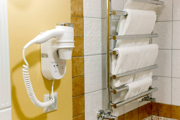 istock Hair dryer in a holder on hotel bath wall. 904218668