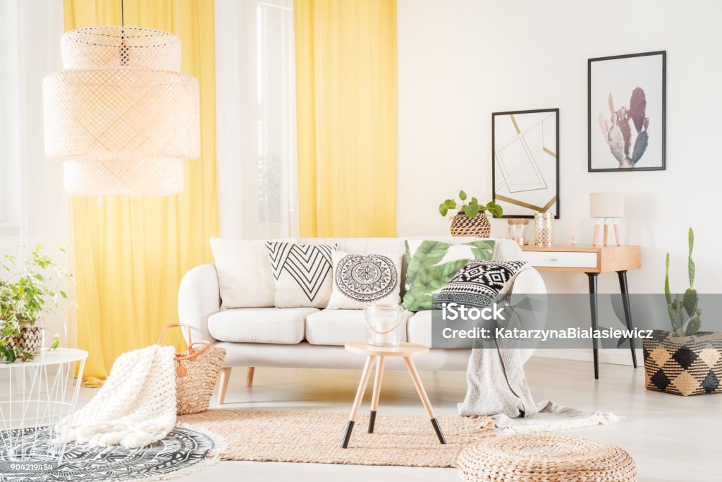 Patterned pillows lying on sofa Patterned pillows lying on a cozy sofa in a bohemian living room interior Multi Colored Stock Photo